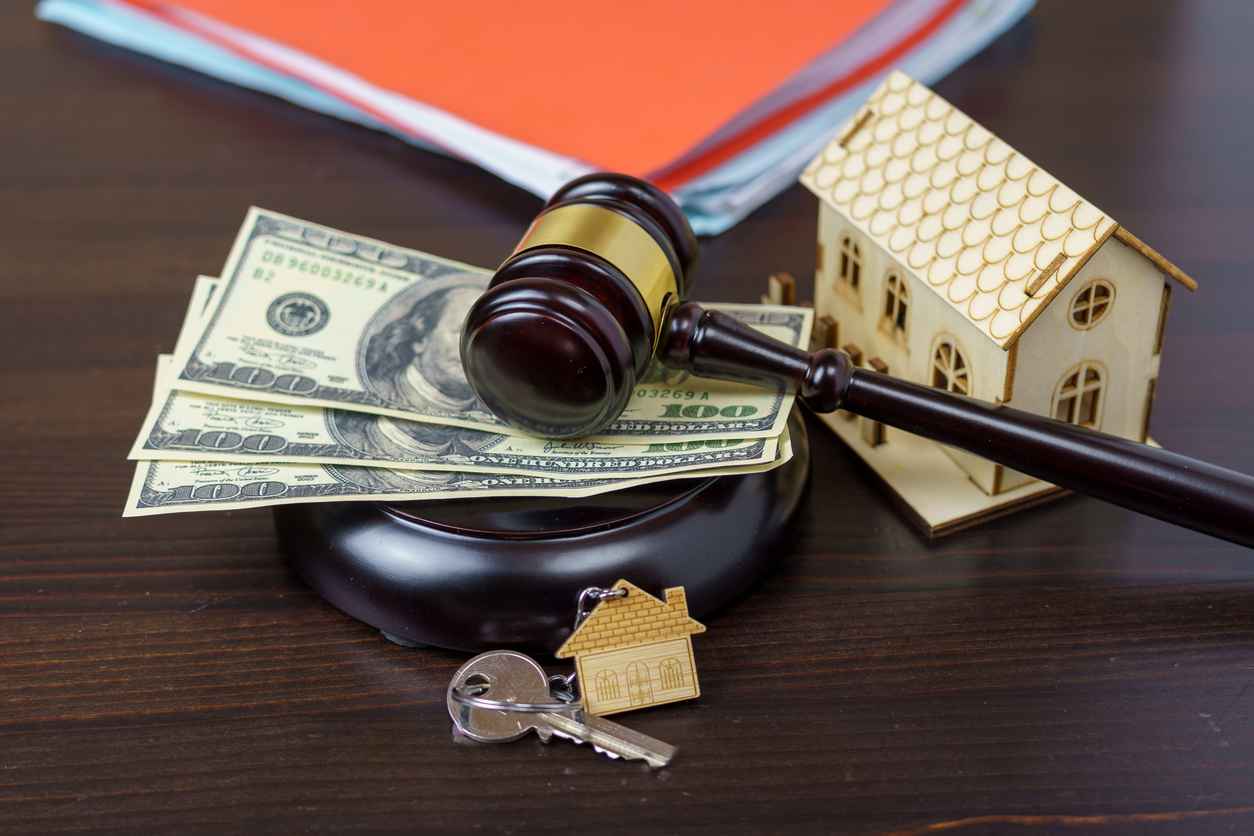 House keys and judge gavel. Concept purchase sale, rent, auction, mortgage. The arrest of property, the imposition of restrictions. Real estate and law concept